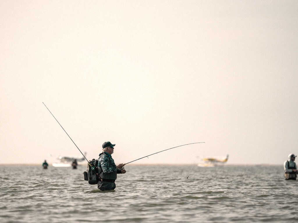 Anglers with floatplanes in the background