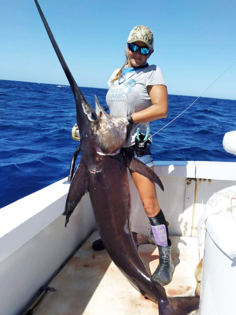 A lady captain holds a nice swordfish caught off the Florida Keys.