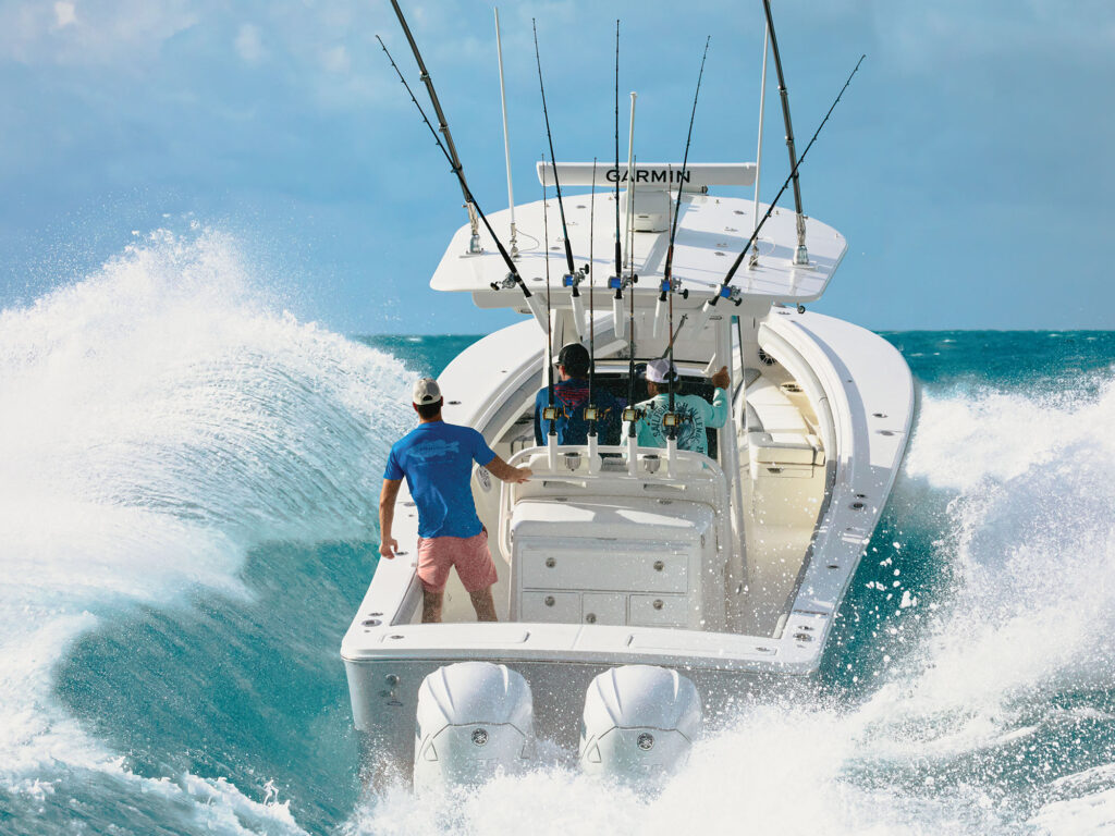 Fishing boat with twin outboards blasting through waves