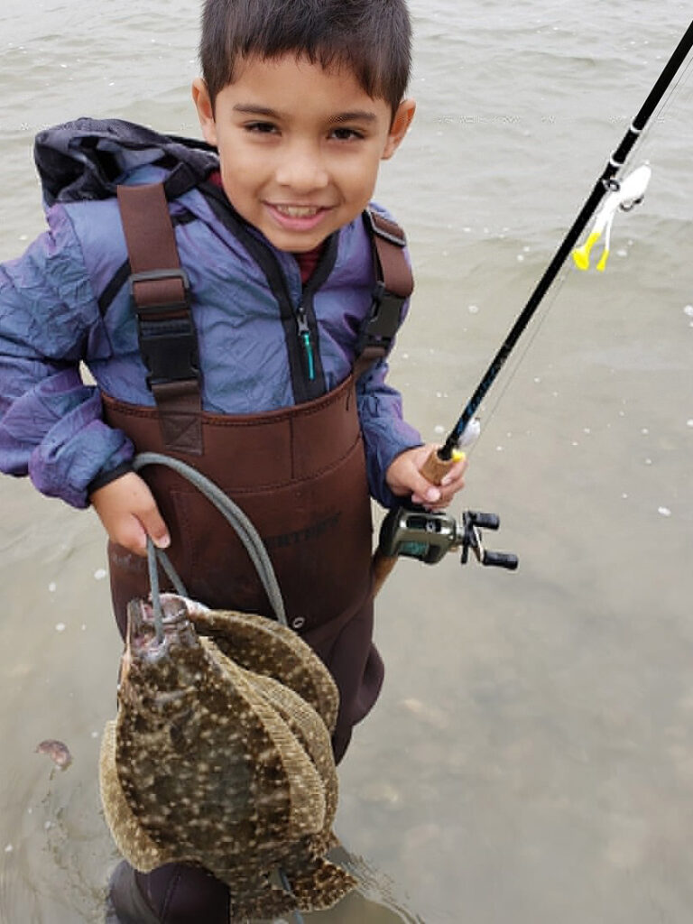 A child with a stringer of flounder.