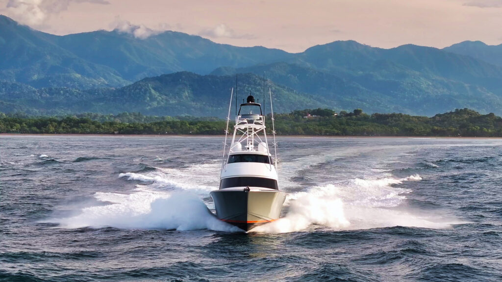 Sport fishing yacht in front of the mountains of Quepos, Costa Rica.