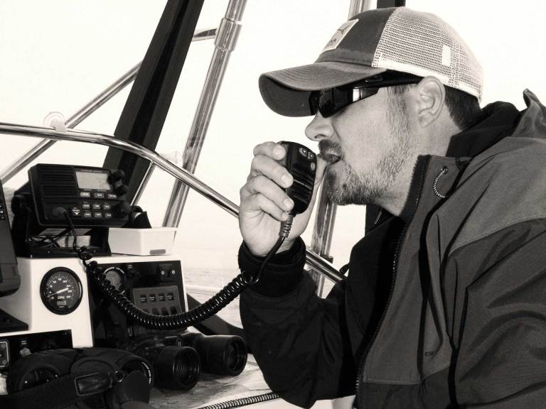 SWS1025-ELC-VHF-1 Angler using a VHF radio