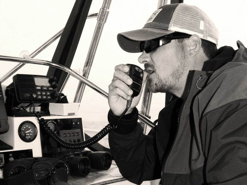 Angler using a VHF radio